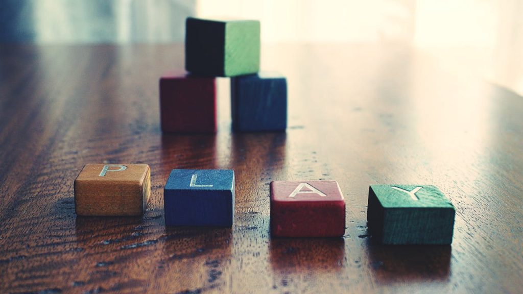 Conceptual Photo of Word "play" Spelled by wooden Blocks.